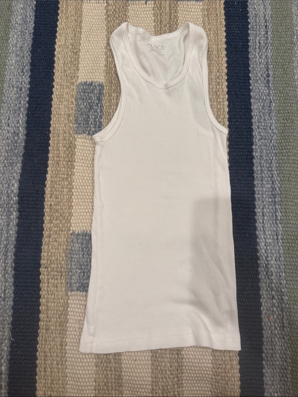 Place White Ribbed Tank very stretchy material
